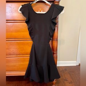 Adorable mini dress with cut outs and ruffle trim on the bottom!!